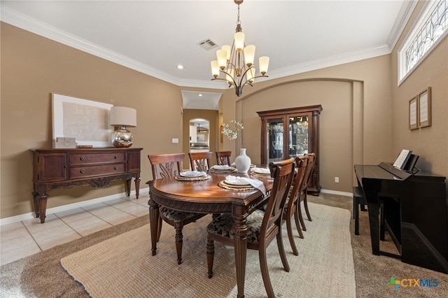 tiled dining room featuring crown molding, a wealth of natural light, and a chandelier