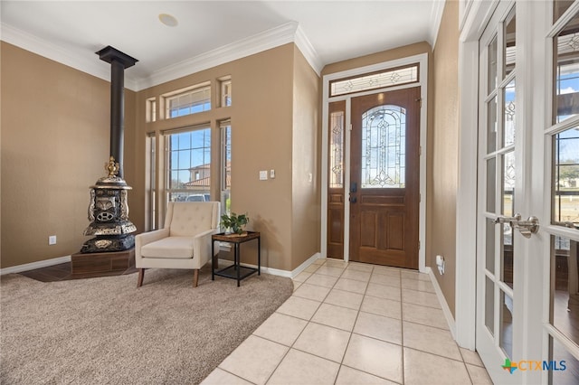 foyer featuring light carpet and ornamental molding