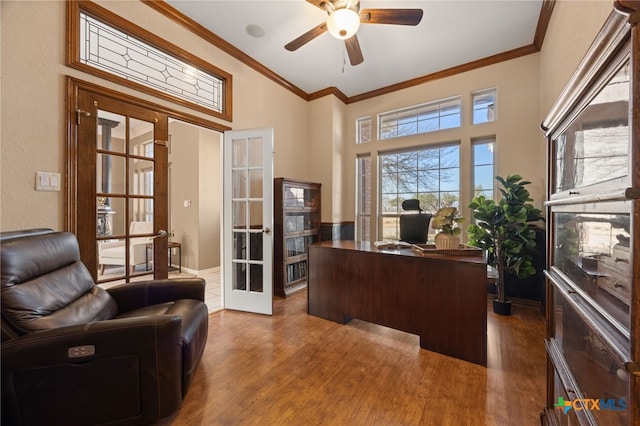 home office featuring hardwood / wood-style floors, ornamental molding, and french doors