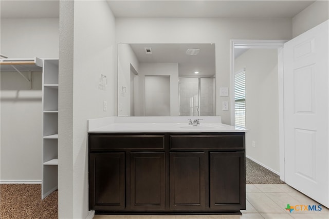 bathroom featuring vanity, an enclosed shower, and tile patterned flooring