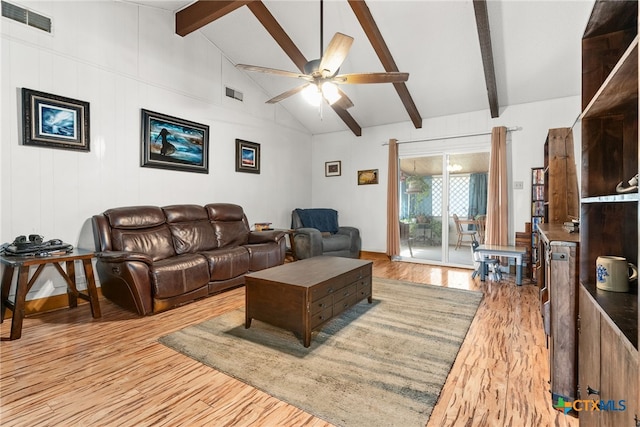 living area featuring light wood finished floors, visible vents, a ceiling fan, and beam ceiling