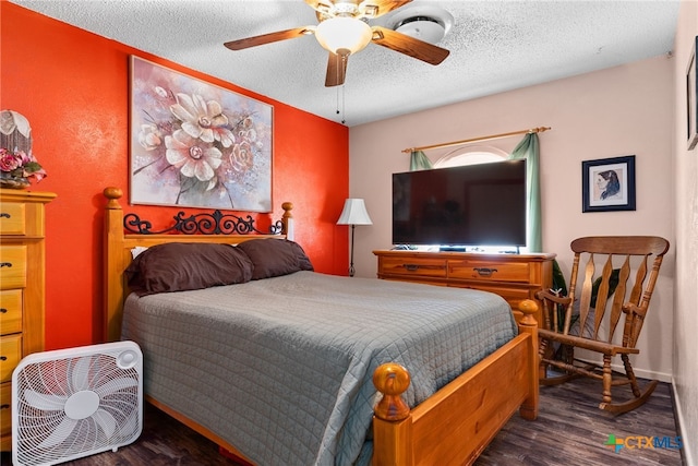 bedroom featuring a ceiling fan, wood finished floors, and a textured ceiling