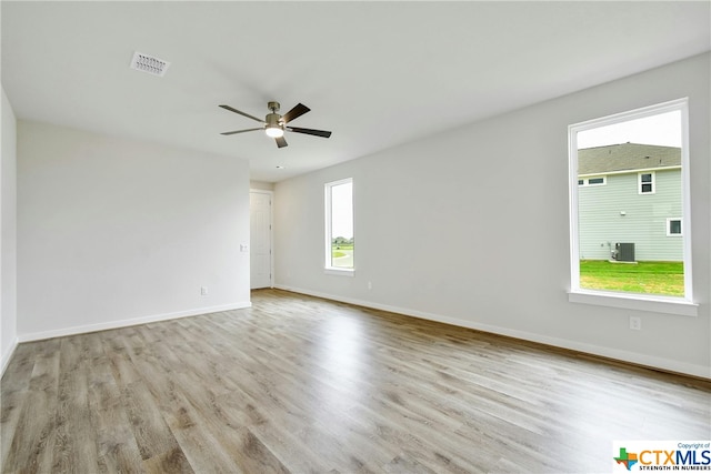 spare room featuring light hardwood / wood-style floors and ceiling fan