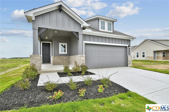 view of front of home with a garage and a front lawn