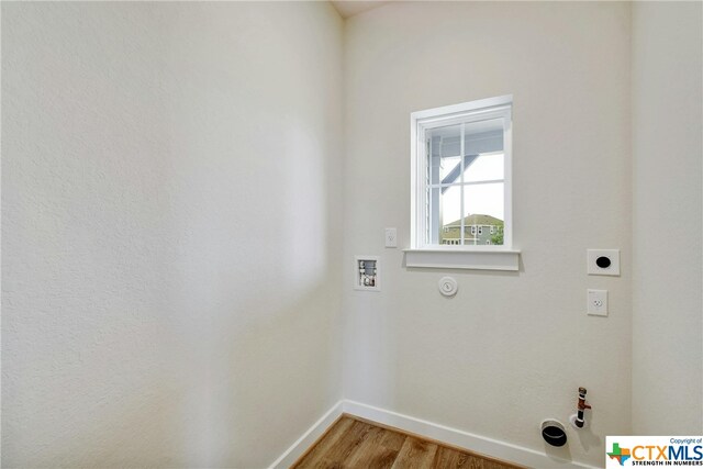 laundry area featuring hardwood / wood-style floors, washer hookup, electric dryer hookup, and hookup for a gas dryer