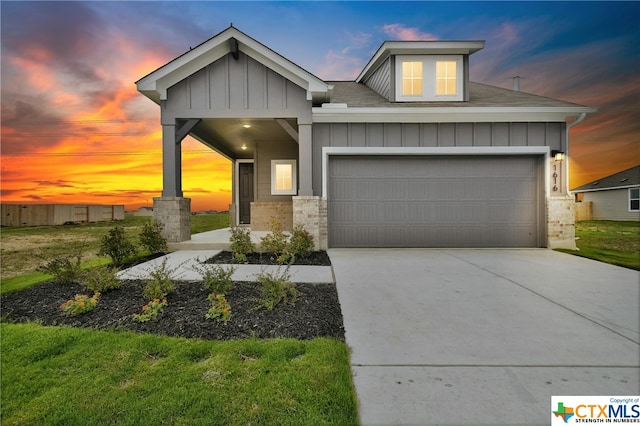 craftsman-style home with a lawn and a garage