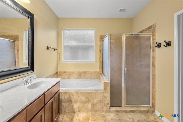 bathroom featuring vanity, tile patterned floors, and shower with separate bathtub