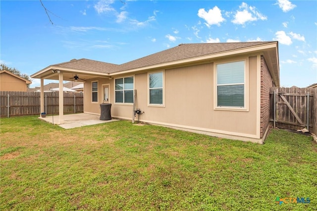 back of property featuring a patio area, ceiling fan, and a lawn