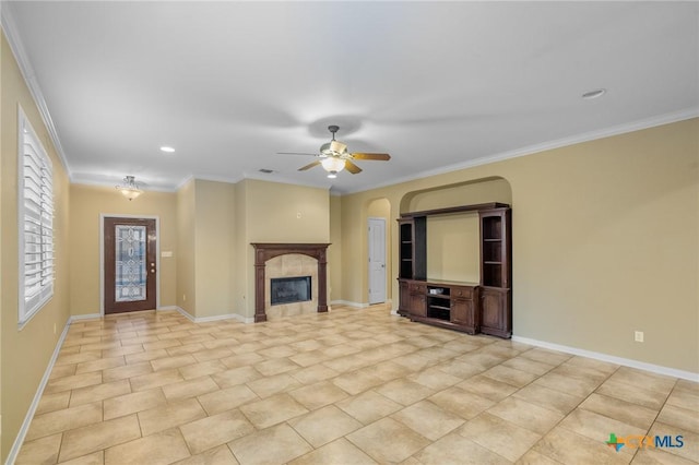 unfurnished living room with crown molding, ceiling fan, a fireplace, and light tile patterned floors