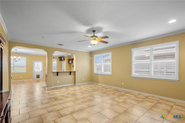 tiled spare room featuring crown molding, ceiling fan with notable chandelier, and a wealth of natural light