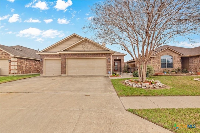 ranch-style home with a garage and a front lawn