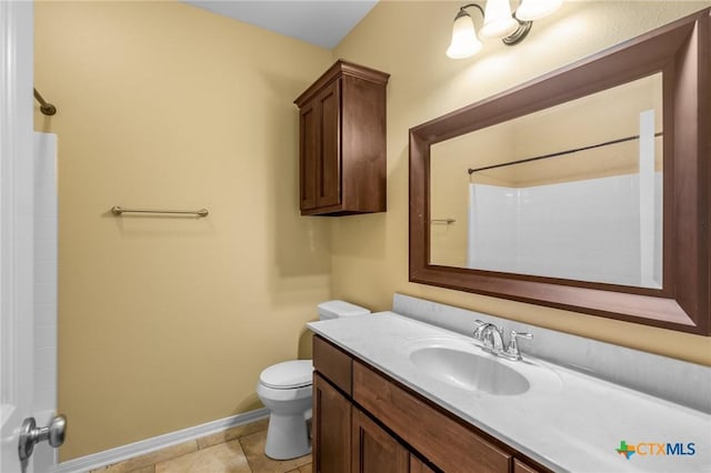 bathroom with vanity, tile patterned floors, a shower, and toilet