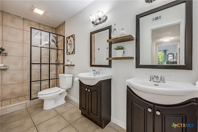 full bath with visible vents, toilet, two vanities, tile patterned flooring, and tiled shower