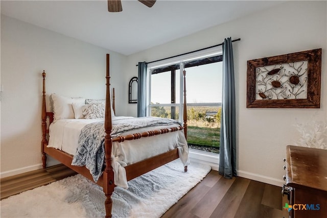 bedroom with baseboards, wood finished floors, and a ceiling fan