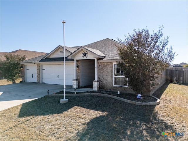 single story home featuring a garage and a front lawn