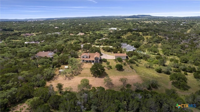 view of property location with a heavily wooded area