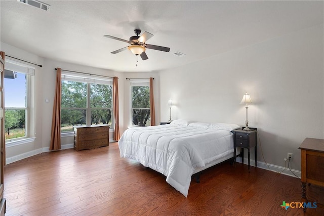 bedroom with wood finished floors, baseboards, and ceiling fan