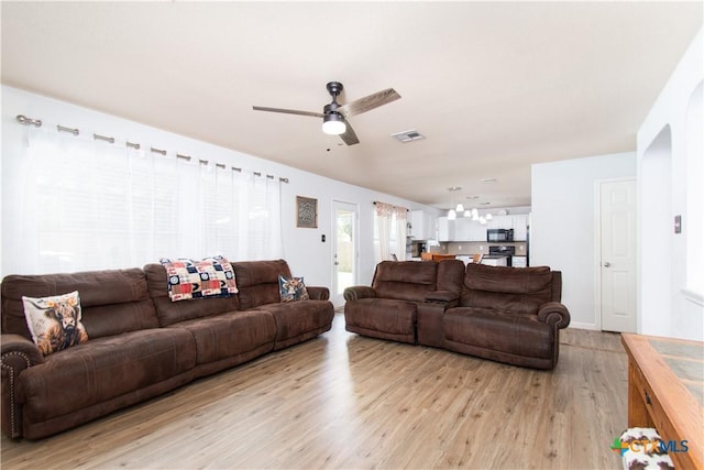 5516 Birmingham Cir, Killeen, TX 76542 - living area featuring light wood-type flooring, ceiling fan, and arched walkways