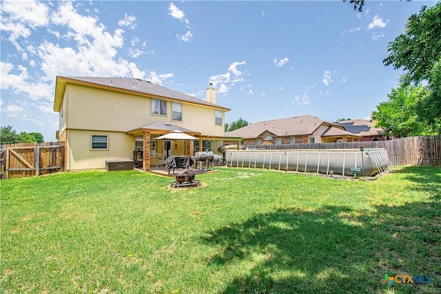 5516 Birmingham Cir, Killeen, TX 76542 - rear view of property featuring a chimney, a fenced backyard, an outdoor fire pit, and a patio area
