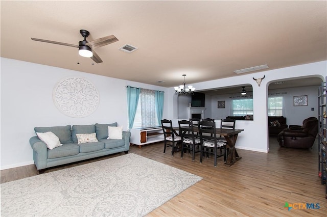5516 Birmingham Cir, Killeen, TX 76542 - living area with wood finished floors, plenty of natural light, a chandelier, and arched walkways