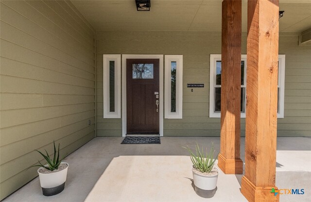 view of exterior entry featuring a porch