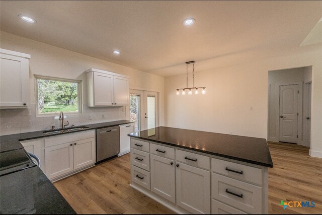 kitchen featuring white cabinets, sink, and dishwasher