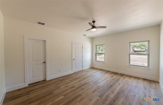 empty room featuring hardwood / wood-style floors and ceiling fan