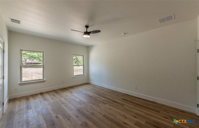 spare room featuring hardwood / wood-style flooring and ceiling fan