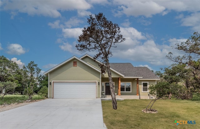 view of front of property featuring a garage and a front lawn