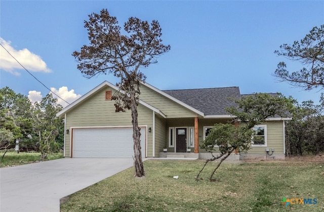 view of front of house featuring a front lawn and a garage