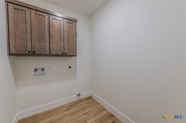 laundry room with cabinets, washer hookup, light wood-type flooring, and electric dryer hookup