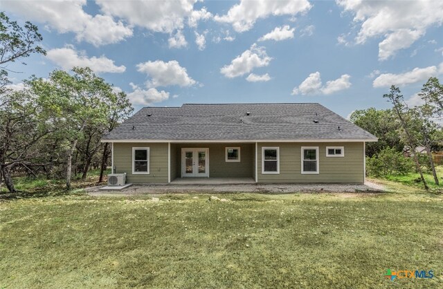 back of property with a patio area, a lawn, and french doors