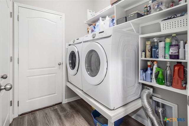 washroom with washing machine and dryer and dark hardwood / wood-style floors