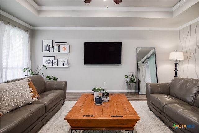 living room with ceiling fan, wood-type flooring, and ornamental molding