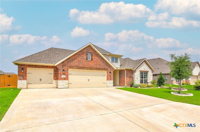 view of front of property featuring a front yard and a garage