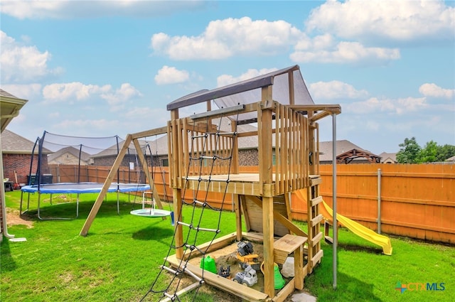 view of jungle gym with a lawn and a trampoline