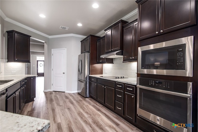 kitchen with light stone countertops, stainless steel appliances, light hardwood / wood-style floors, dark brown cabinets, and ornamental molding