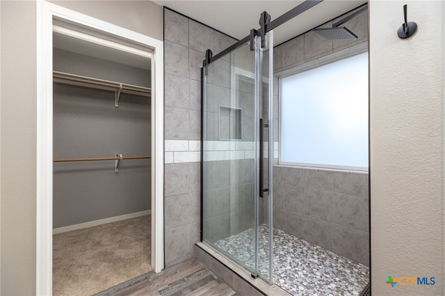 bathroom with hardwood / wood-style floors and walk in shower