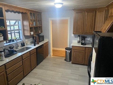 kitchen featuring light wood-type flooring, sink, and black appliances