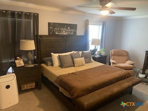 319 W Village Rd, Salado, TX 76571 - carpeted bedroom featuring ornamental molding and a ceiling fan
