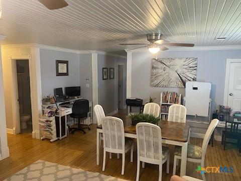 319 W Village Rd, Salado, TX 76571 - dining space featuring a ceiling fan, ornamental molding, an office area, and wood finished floors