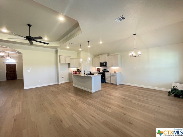 kitchen with white cabinets, stainless steel appliances, an island with sink, and light hardwood / wood-style flooring