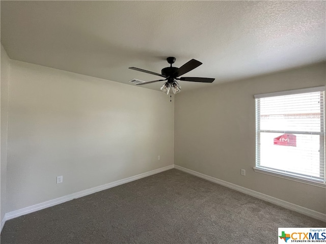 unfurnished room with ceiling fan, a textured ceiling, and carpet flooring