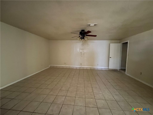 tiled empty room with ceiling fan