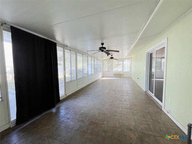 unfurnished sunroom featuring ceiling fan