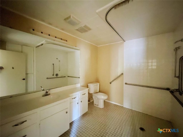 bathroom with tile patterned floors, vanity, and toilet