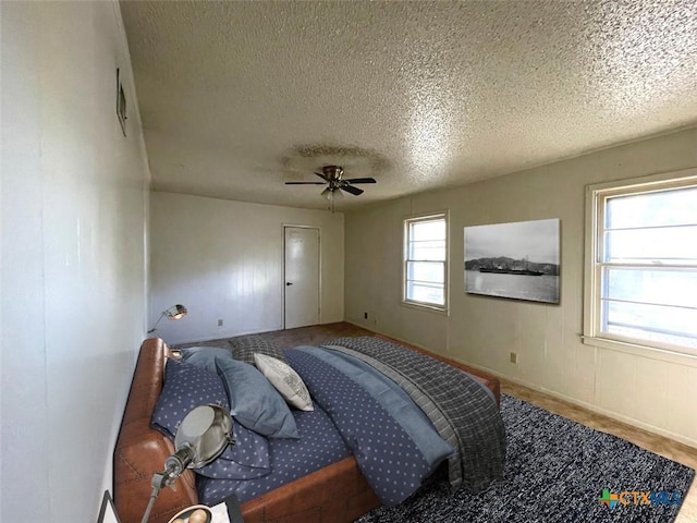 bedroom featuring a textured ceiling, hardwood / wood-style flooring, and ceiling fan