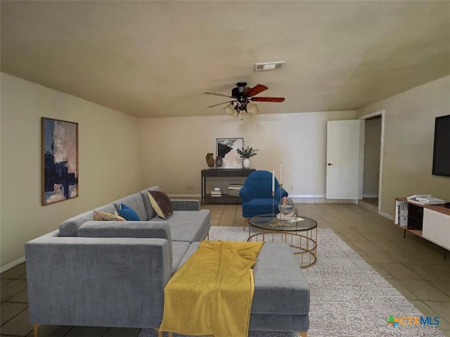 living room featuring ceiling fan and light tile patterned floors