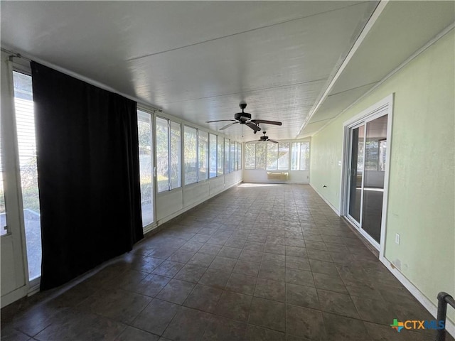 unfurnished sunroom featuring ceiling fan