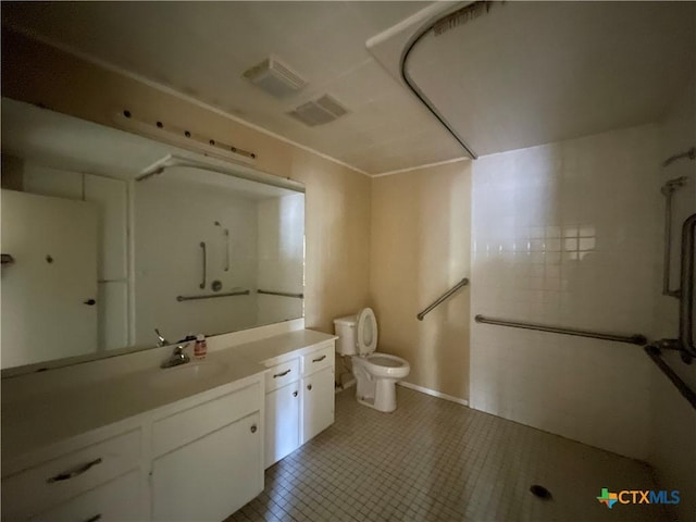 bathroom with tile patterned flooring, vanity, and toilet